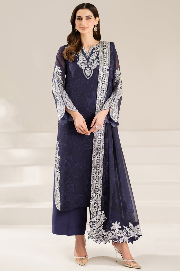 Woman wearing a navy blue traditional outfit with white embroidery By Farasha pakistani fashion brand