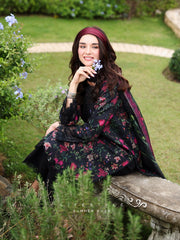 Woman in a floral dress sitting on a stone bench in a garden