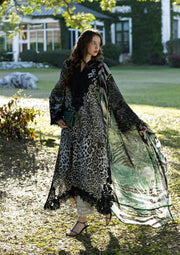 Woman in a leopard print dress standing outdoors with greenery in the background