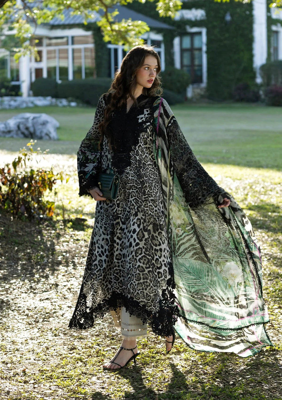 Woman in a leopard print dress standing outdoors with greenery in the background