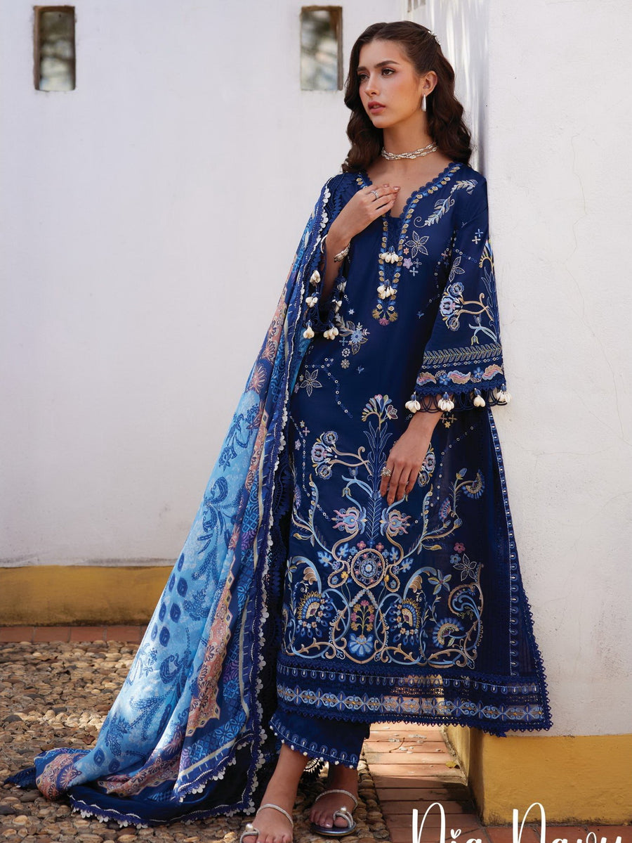 Woman wearing a blue embroidered traditional outfit with a matching dupatta.