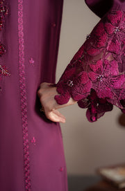 Close-up of a purple embroidered garment with floral patterns.