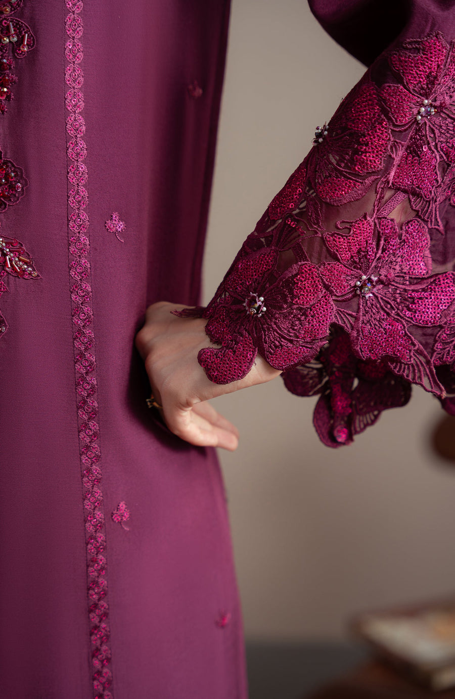 Close-up of a purple embroidered garment with floral patterns.