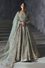 A model wearing an Afrozeh luxury bridal organza unstitched 3-piece suit, consisting of a front-open style gown with intricate embroidery, a dupatta, and a trouser made of raw silk.