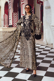 Woman in a patterned dress standing on a checkered floor with decorative walls.