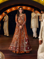 Ayeza khan in an ornate orange and red traditional outfit by Nureh Jhoomro 2025 collection