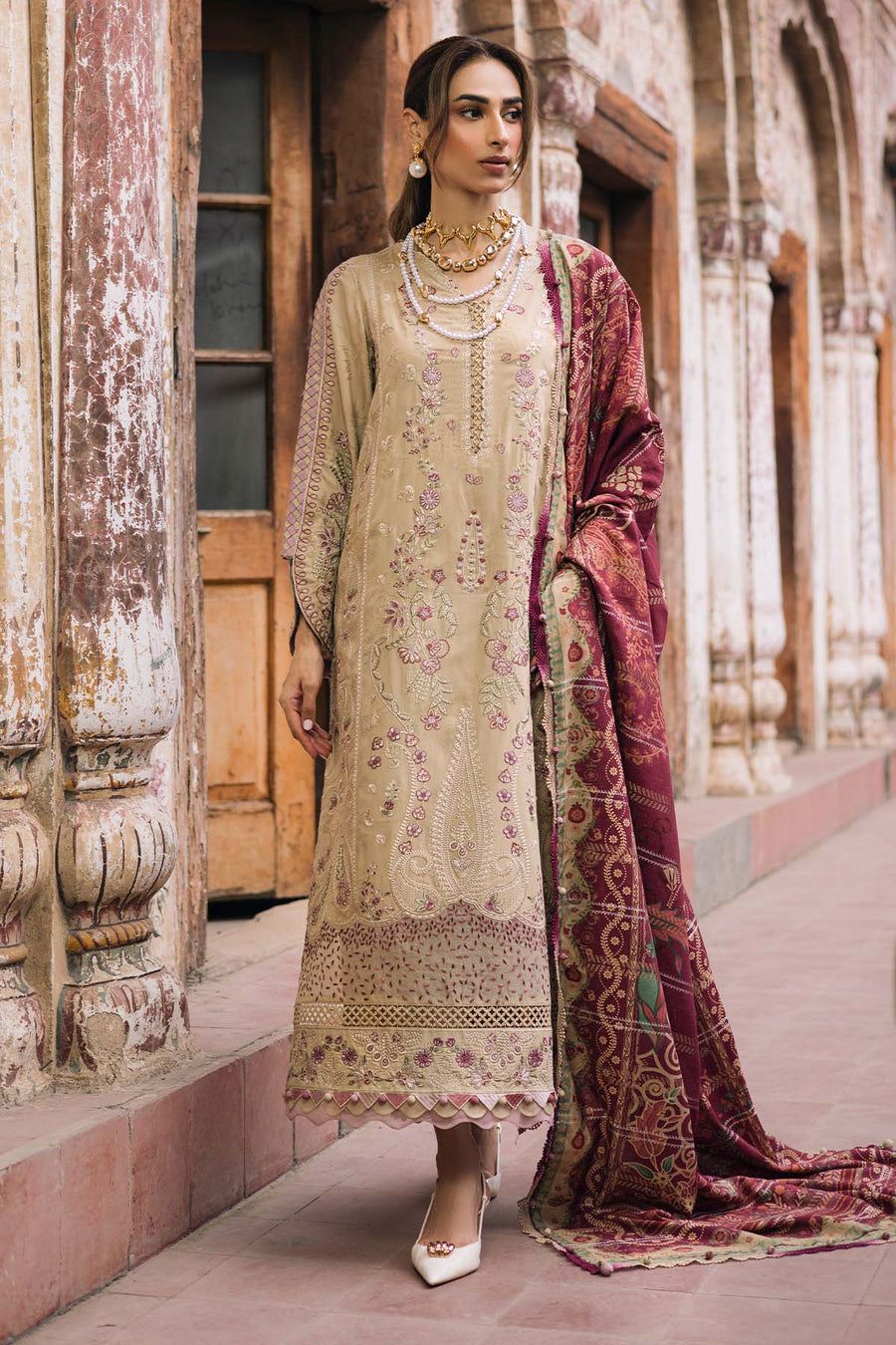 Woman in traditional attire standing in an architectural setting