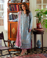 Resham  in a light blue embroidered outfit with pink dupatta standing in a decorated room. Mush Suehri Ramsha Eidt
