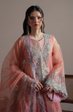 Woman wearing a traditional pink embroidered outfit with a sheer dupatta.