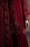 Close-up of a red embroidered garment with intricate patterns.