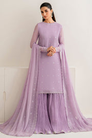 Woman wearing a lavender traditional outfit with a matching dupatta against a white background