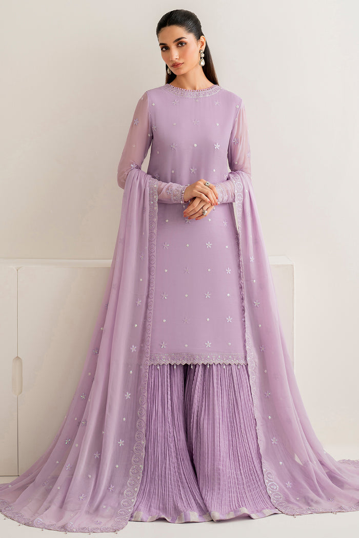 Woman wearing a lavender traditional outfit with a matching dupatta against a white background