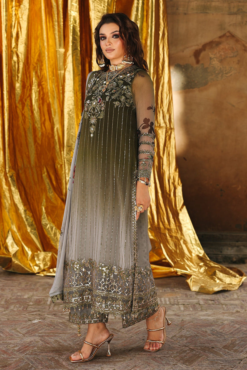 Woman in an embroidered traditional outfit standing in front of a gold curtain.